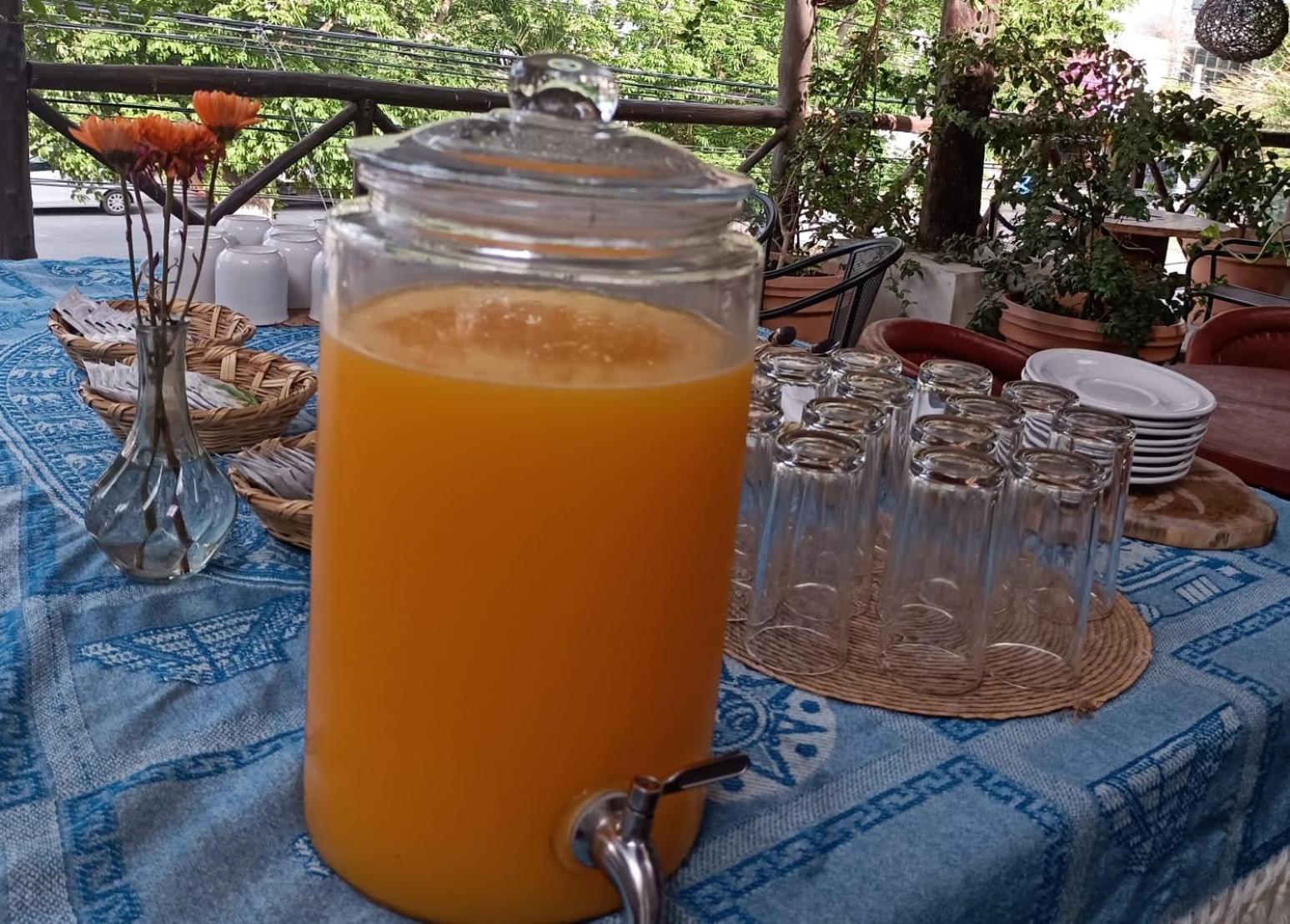 Mio Tulum Hotel Boutique Exteriör bild A glass dispenser of freshly squeezed orange juice